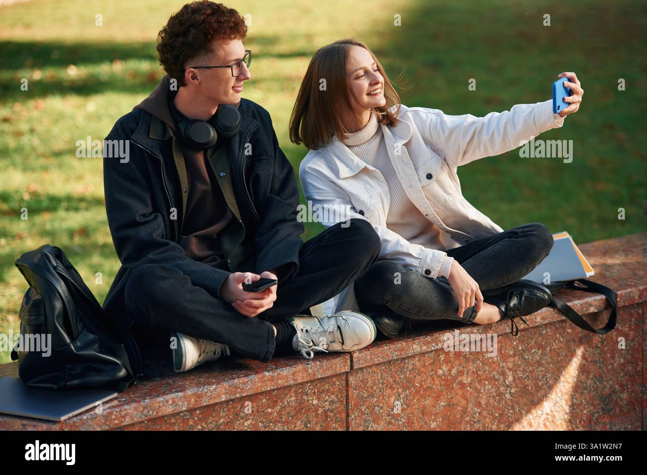 Taking a selfie. Two young students are together outdoors. Stock Photo