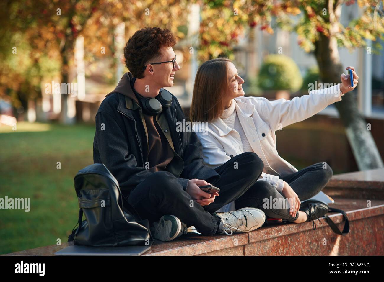 Taking a selfie. Two young students are together outdoors. Stock Photo
