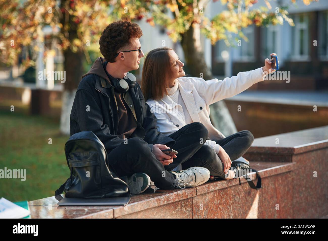 Taking a selfie. Two young students are together outdoors. Stock Photo