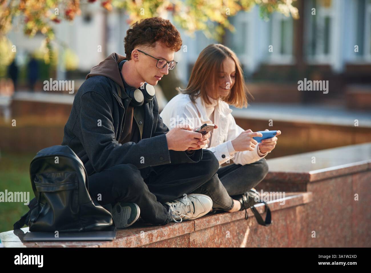 Two young students are together outdoors. Stock Photo