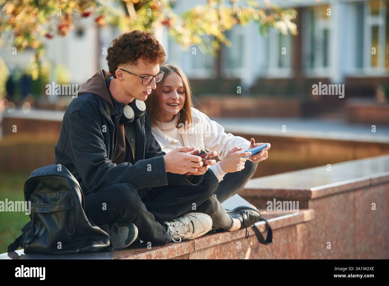 Two young students are together outdoors. Stock Photo