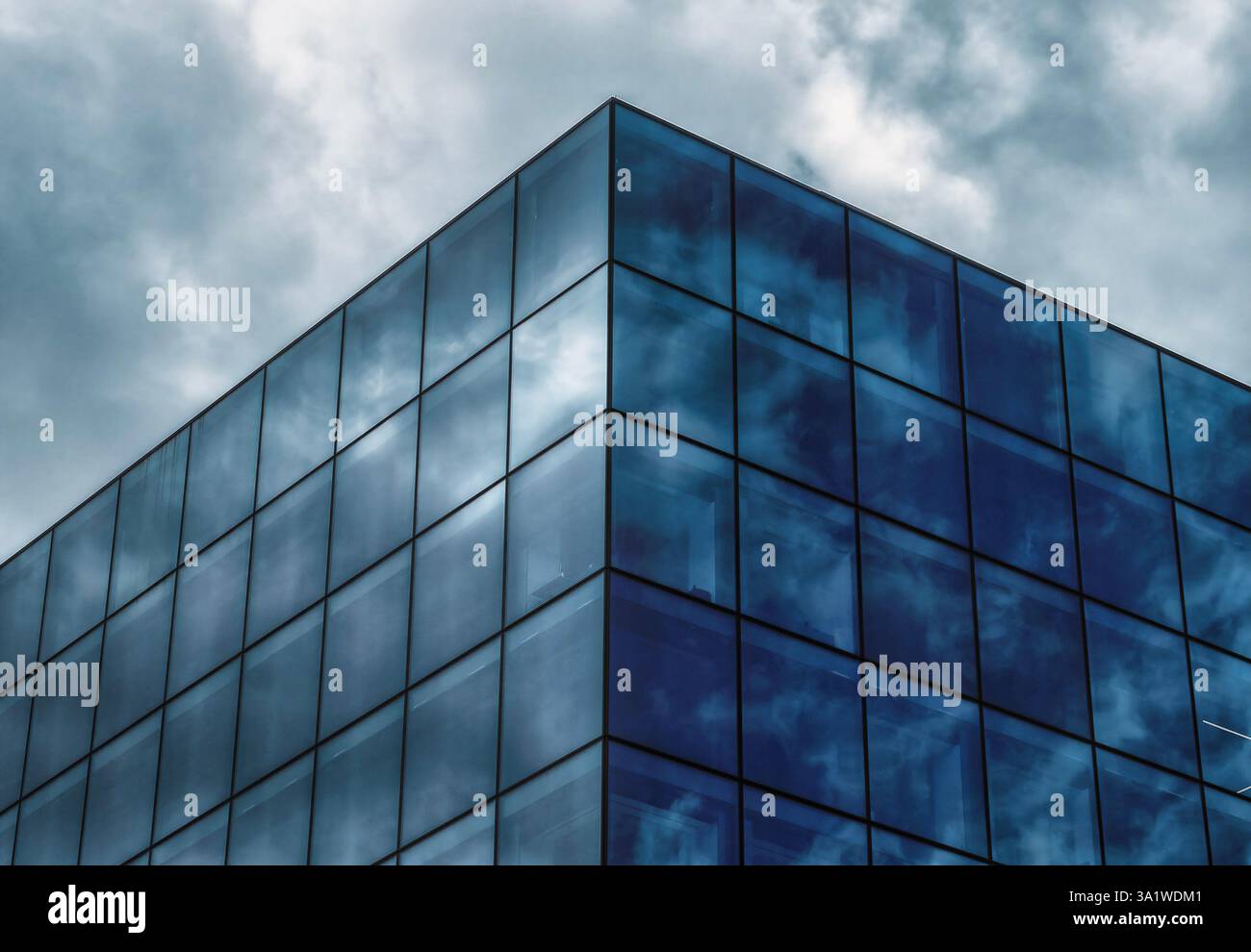 Sky reflected in a glass sided office building Stock Photo - Alamy