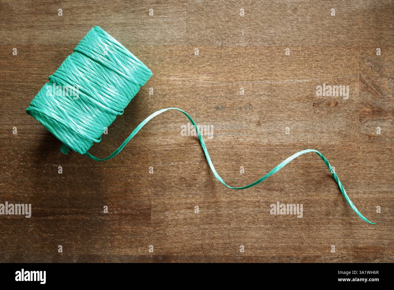Roll of nylon poly garden twine on rustic wood Stock Photo