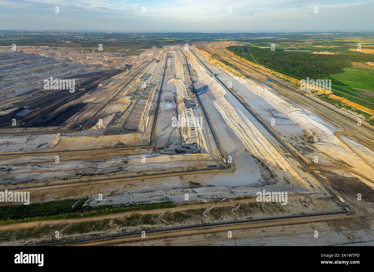 Aerial view, opencast lignite mine Hambach Forest, lignite mining Rhenish mining area, nature overexploitation, bucket wheel excavator, distant view, Stock Photo