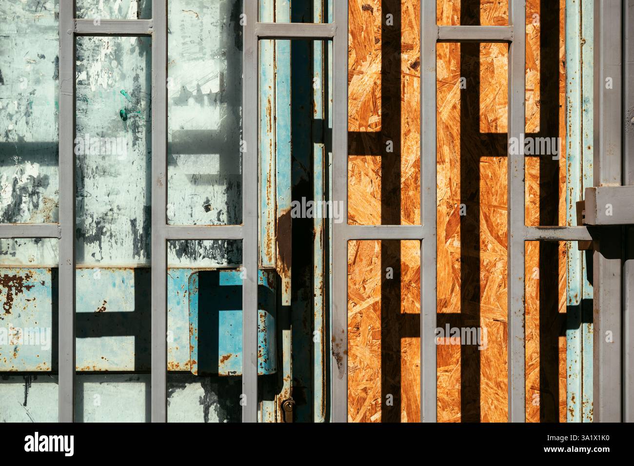 Shopwindow protective security bars on old abandoned store as urban pattern Stock Photo