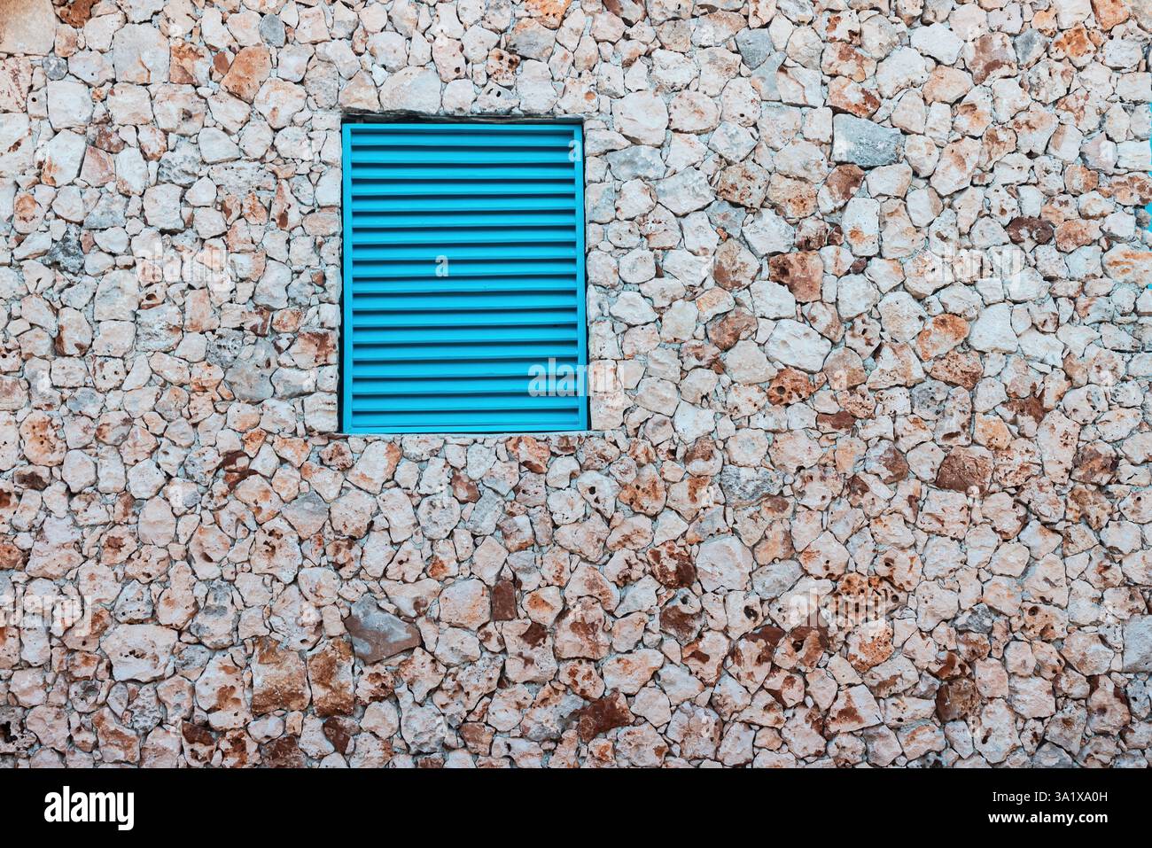 Stone Wall Texture Background With Antique Blue Shutters Window Stock Photo
