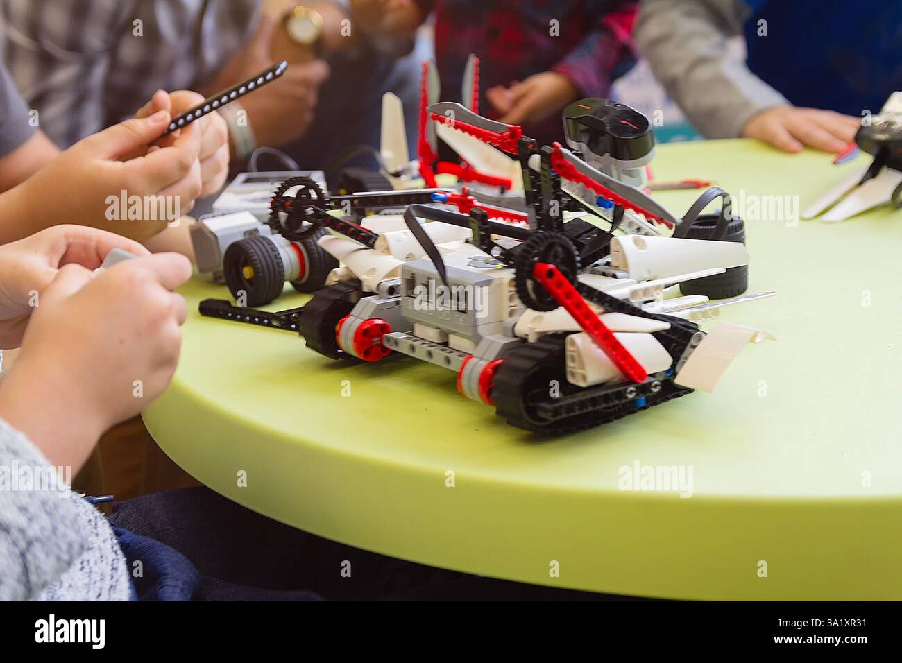 Children are working on model assembly in robotics class. Education Stock Photo