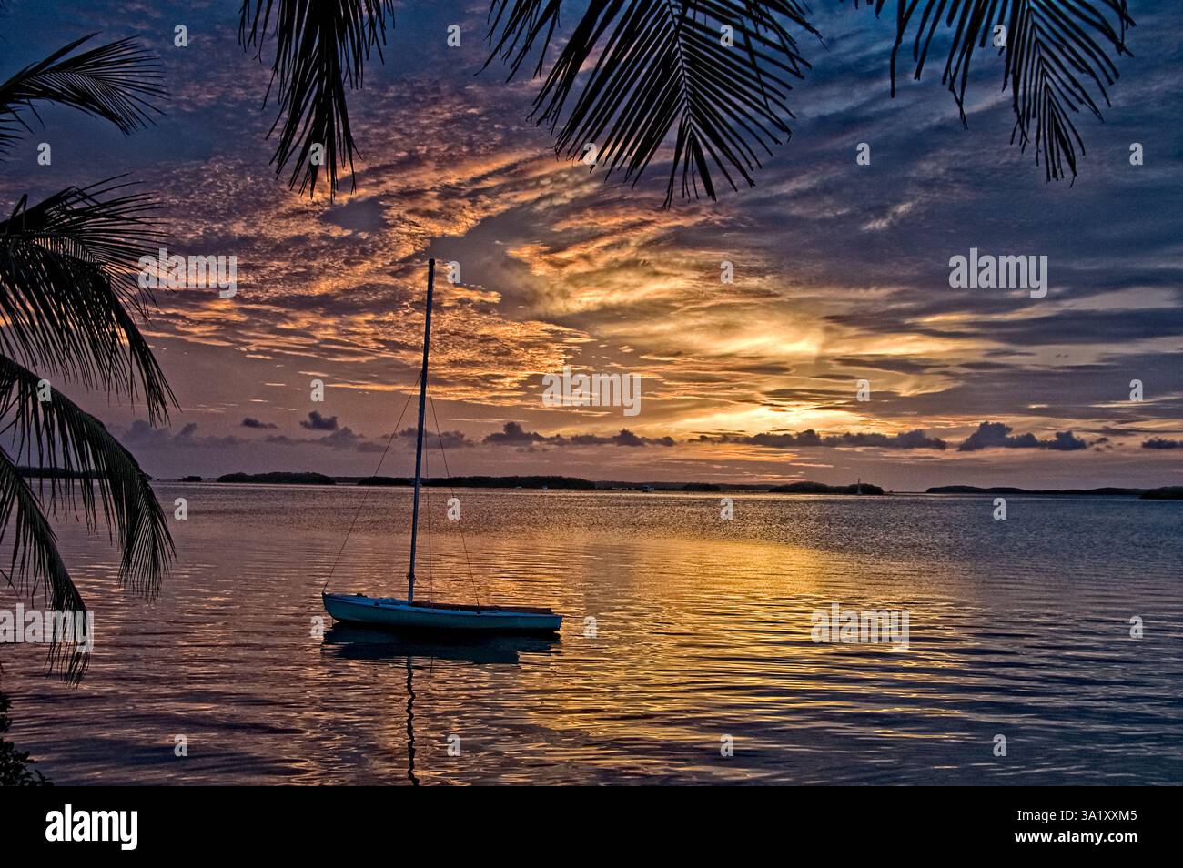 Boat anchored in the bay at Sunset in the Florida Keys Stock Photo - Alamy