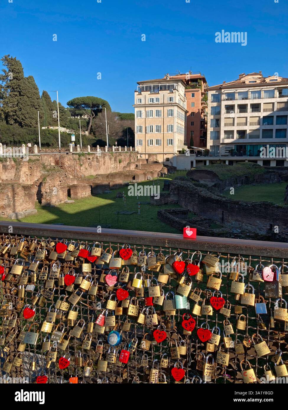 Italy, Lazio, Rome, Piazza Colosseo Square,  Padlock with Heart Shape attached to Fence Ruins of Ludus Magnus - Smartphone Captured Stock Image