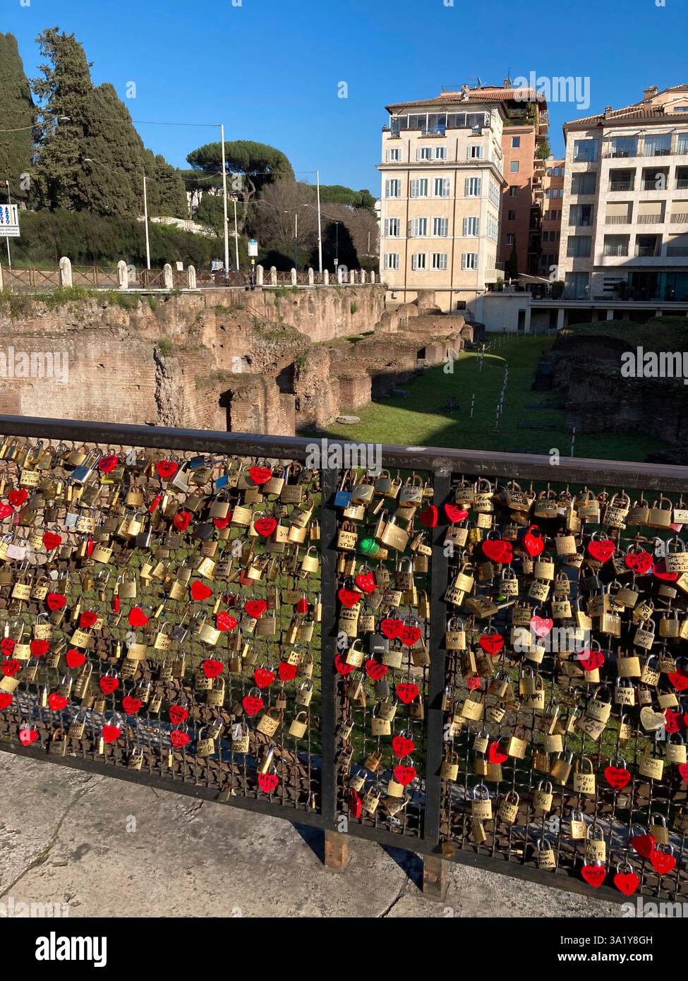 Italy, Lazio, Rome, Piazza Colosseo Square,  Padlock with Heart Shape attached to Fence Ruins of Ludus Magnus - Smartphone Captured Stock Image