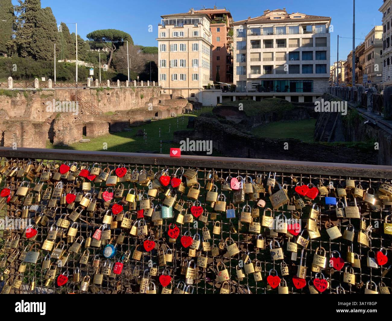 Italy, Lazio, Rome, Piazza Colosseo Square,  Padlock with Heart Shape attached to Fence Ruins of Ludus Magnus - Smartphone Captured Stock Image