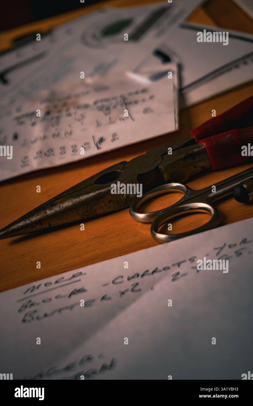 tools and paper with personal notes spread out on a table Stock Photo