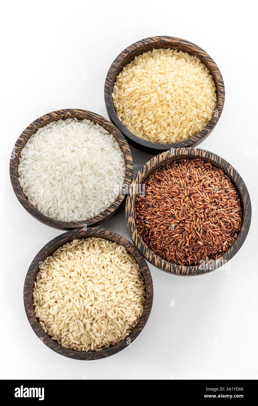 different kinds of asian rice grains in bowls on white background in ...
