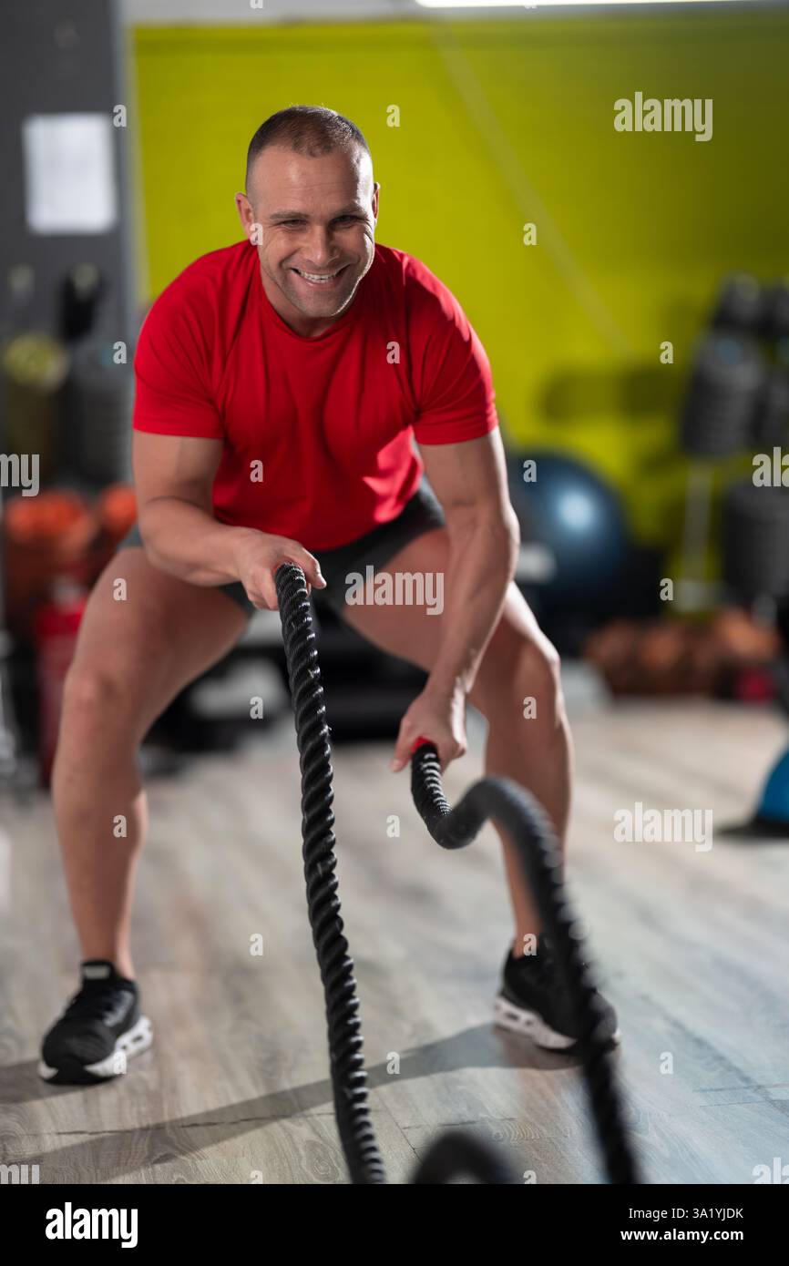 A determined man pushes his limits as he performs intense cardio ...