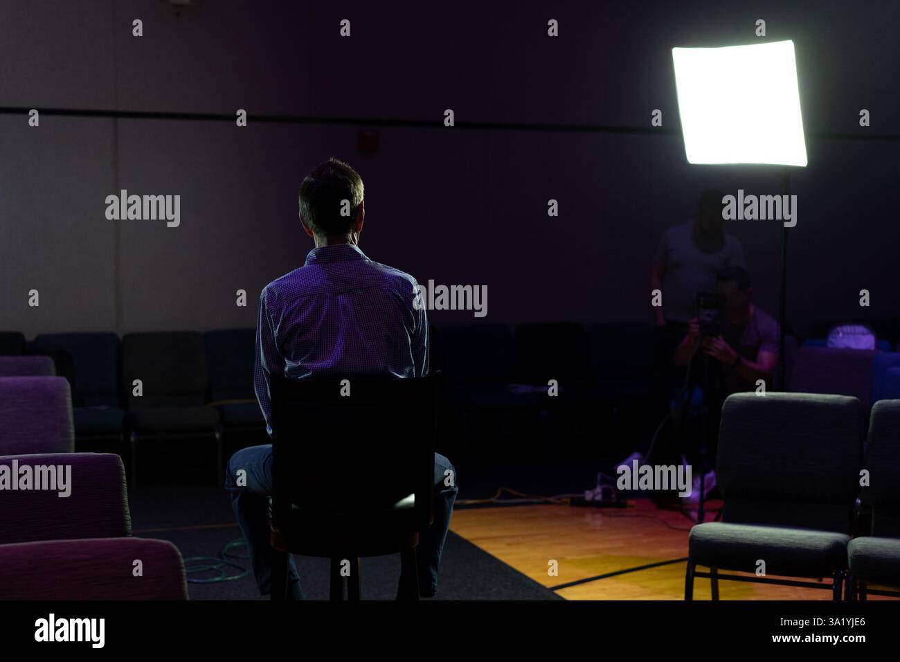 Silhouette of a Man Being Interviewed Stock Photo