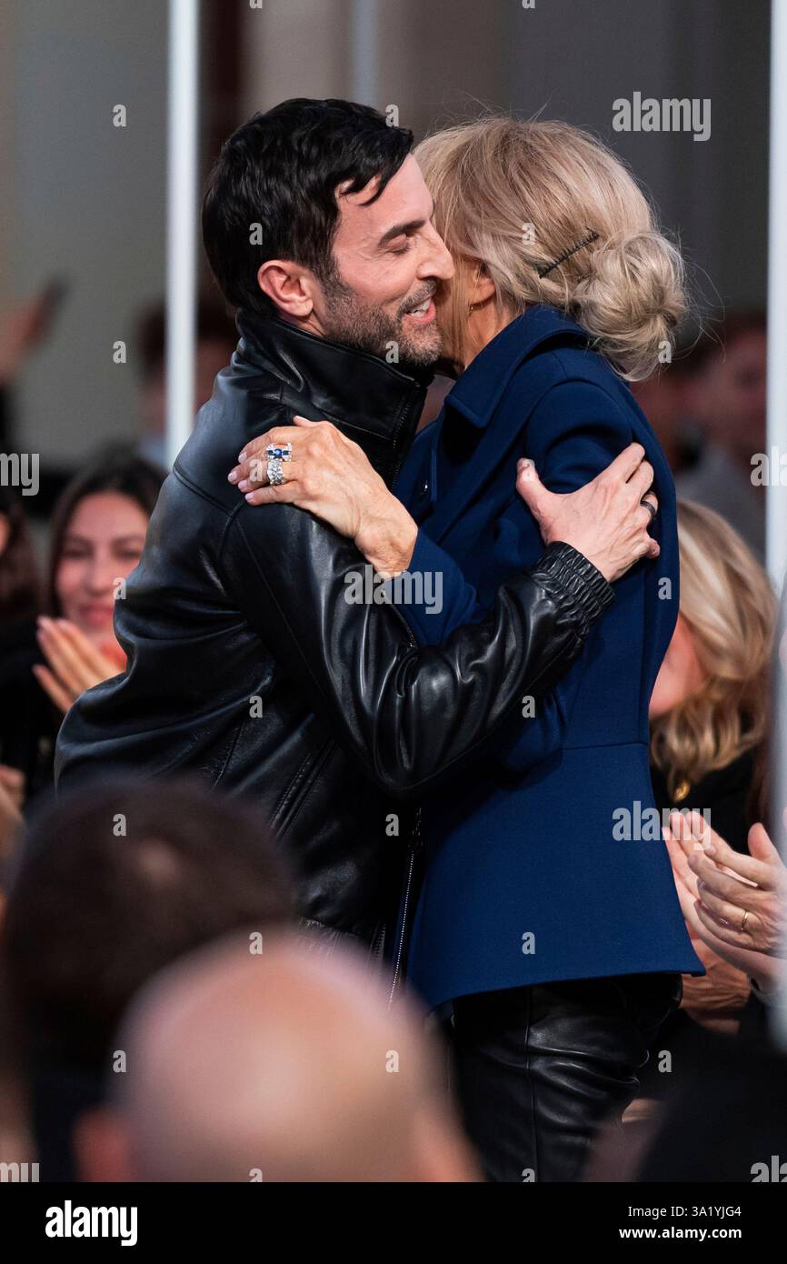 Designer Nicolas Ghesquiere, left, is congratulated by Brigitte Macron, following the Louis