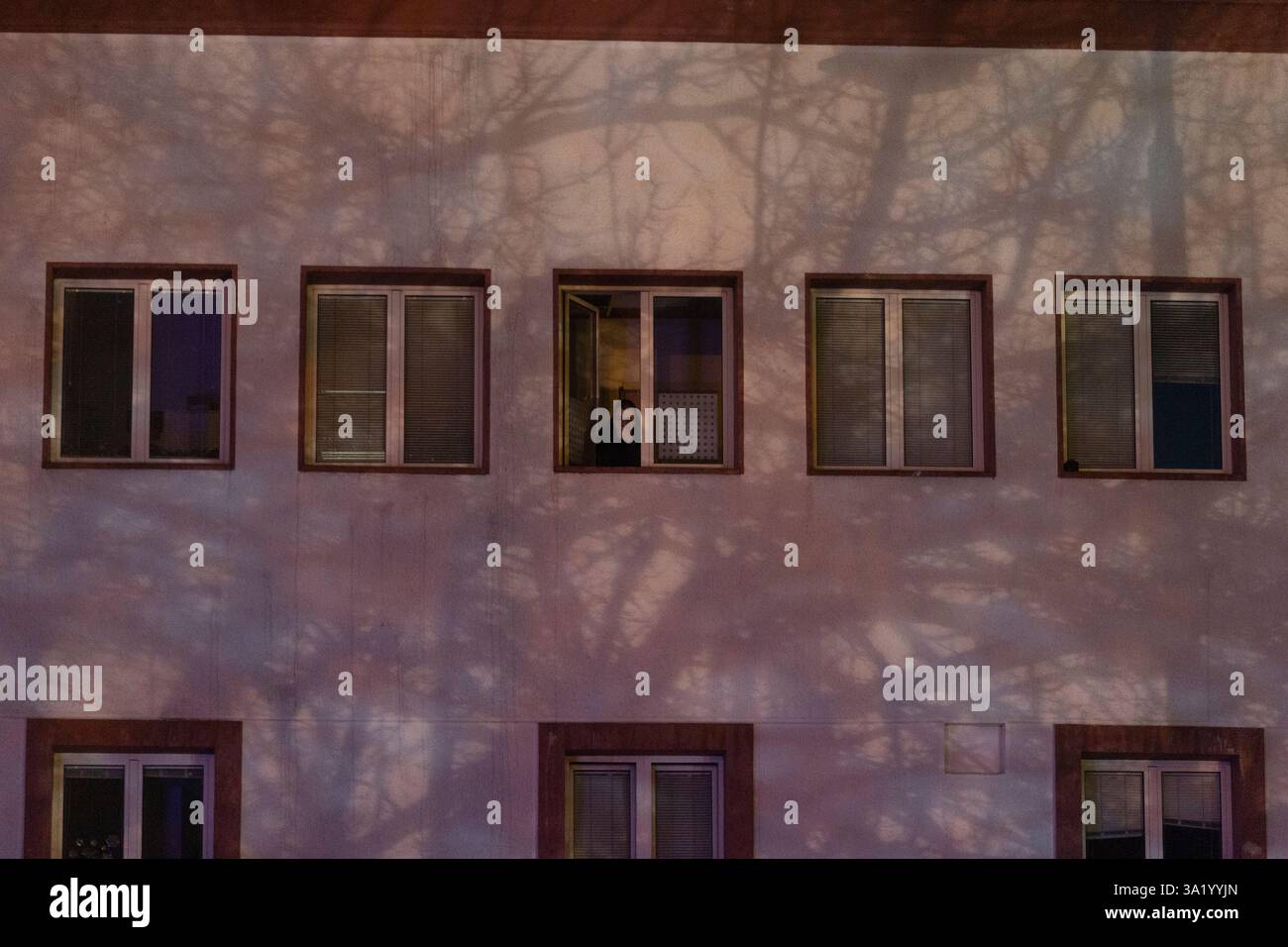 A man peers through the window of the Serbian public broadcaster RTS ...