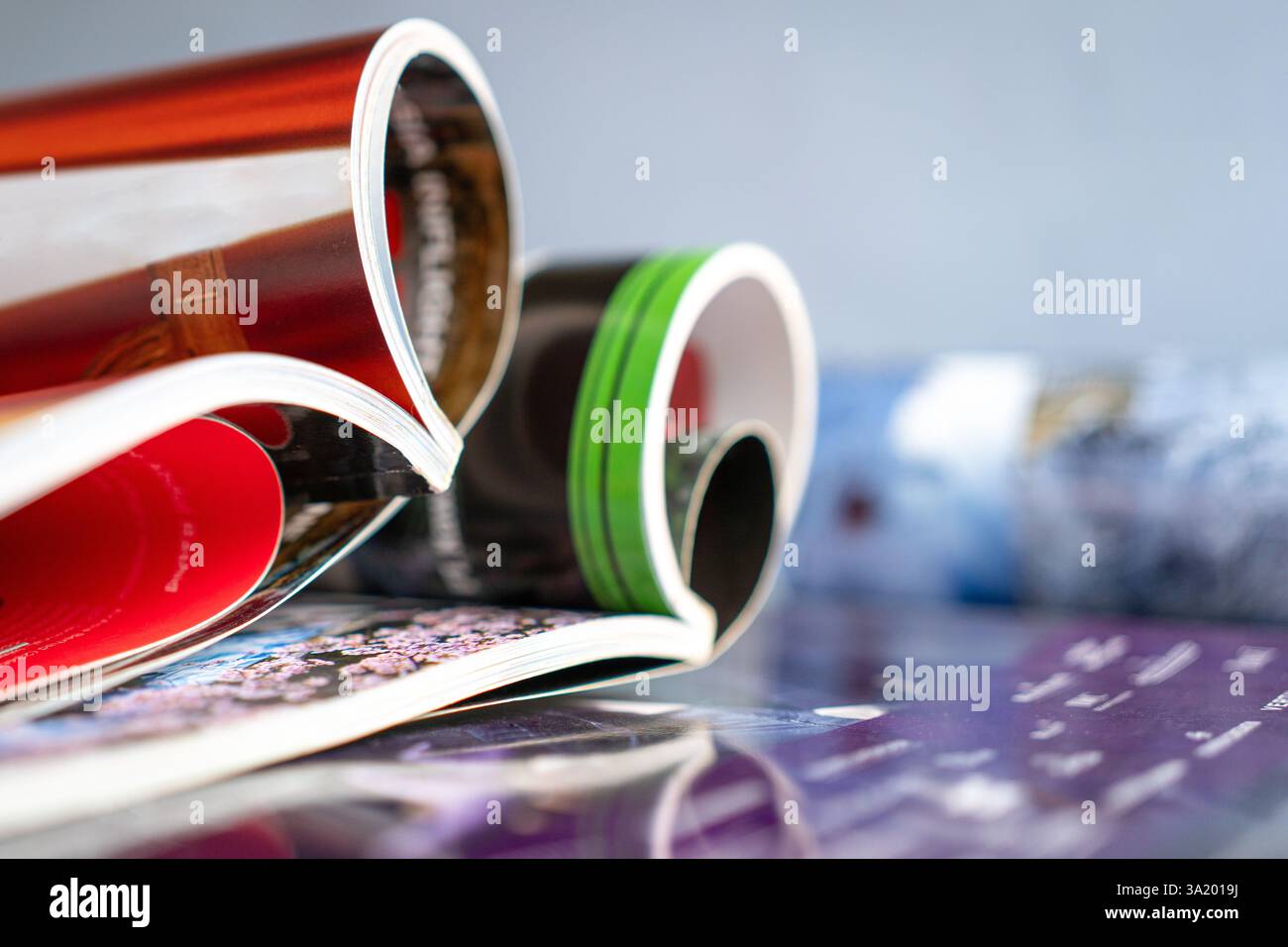Stack and rolled magazines, copy space. Stock Photo