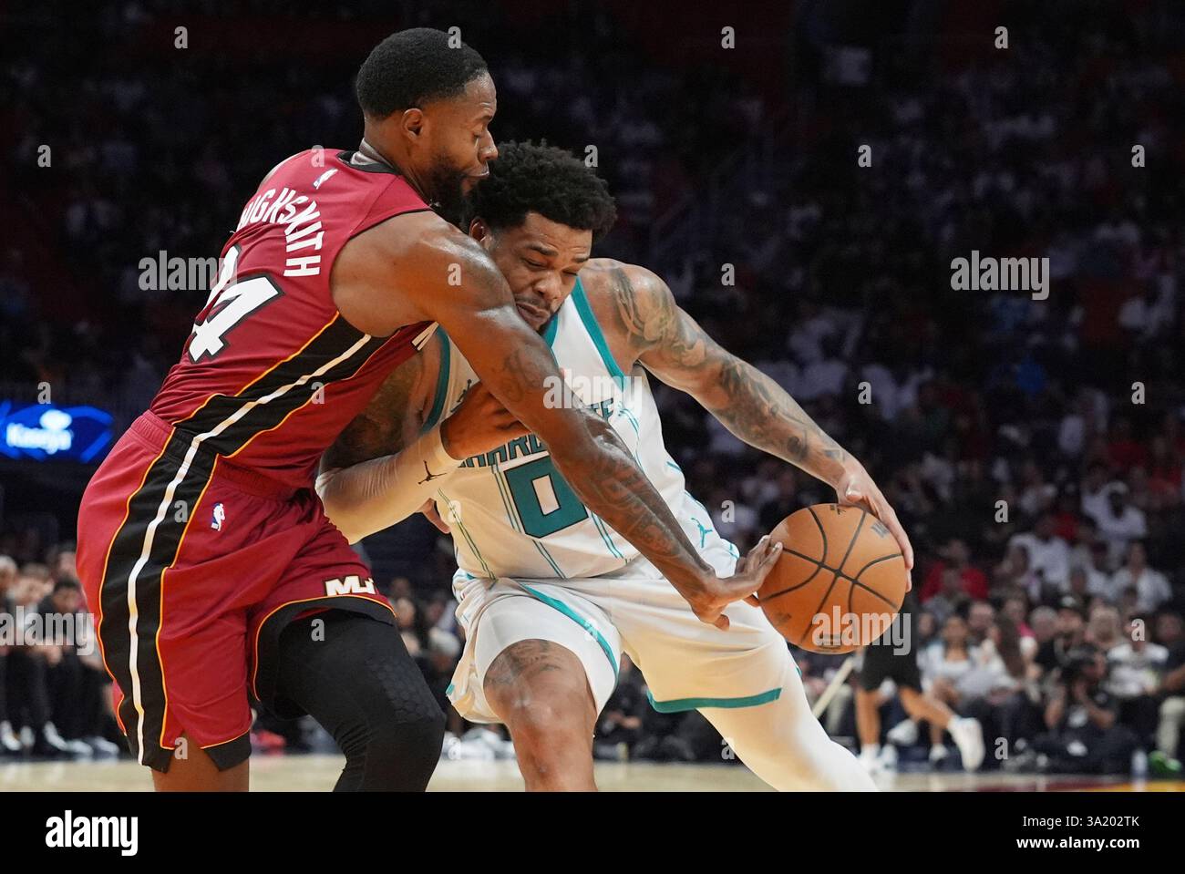 Miami Heat forward Haywood Highsmith (24) defends Charlotte forward Miles Bridges (0