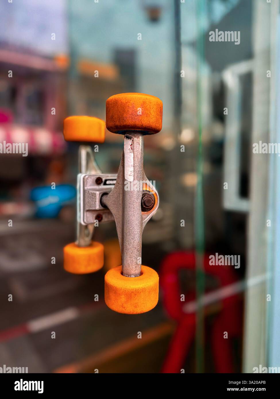 Unique door handle made from skateboard wheels 4 A creative door handle designed using a skateboard truck and wheels, mounted on a glass door. The inn - Smartphone Captured Stock Image