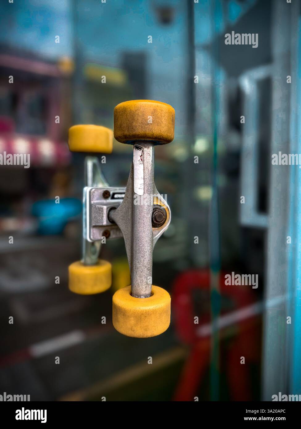 Unique door handle made from skateboard wheels 3 A creative door handle designed using a skateboard truck and wheels, mounted on a glass door. The inn - Smartphone Captured Stock Image
