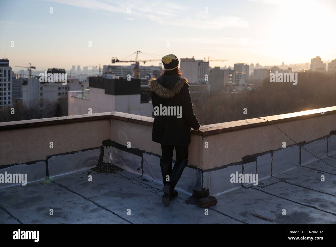 Tehran Rooftops PRODUCTION - 28 February 2025, Iran, Teheran: An interviewee looks out ...