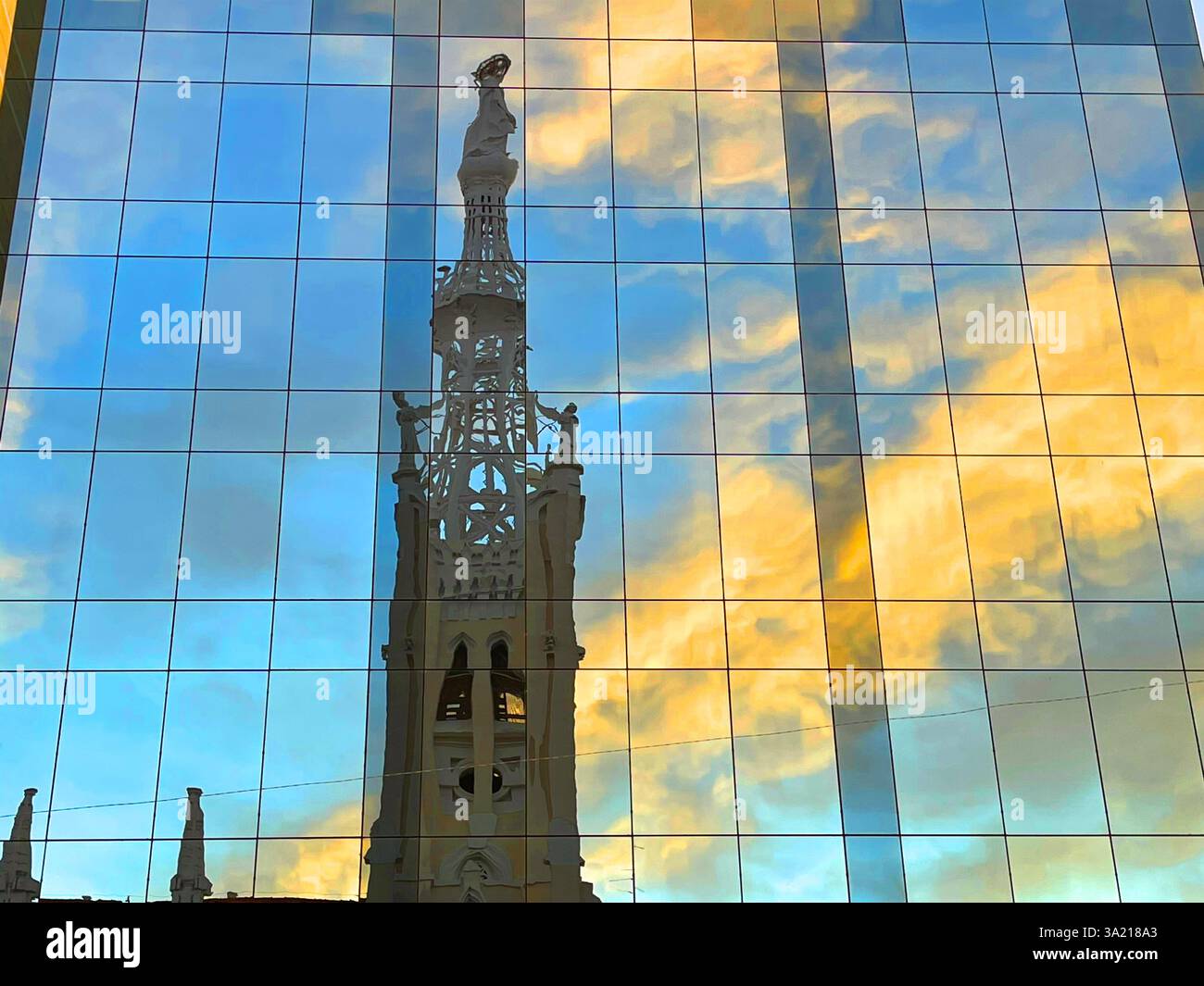 Tower of La Concepcion church reflected on glass facade. Goya street, Madrid, Spain. - Smartphone Captured Stock Image