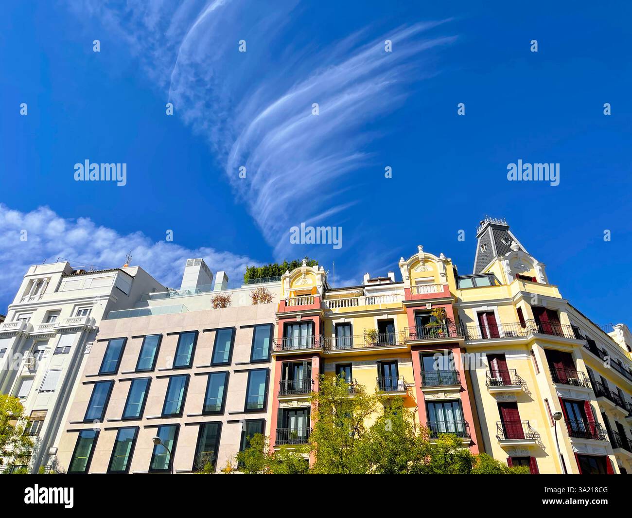 Facades of buildings and cirrus cloud. Alcala street, Madrid, Spain. - Smartphone Captured Stock Image
