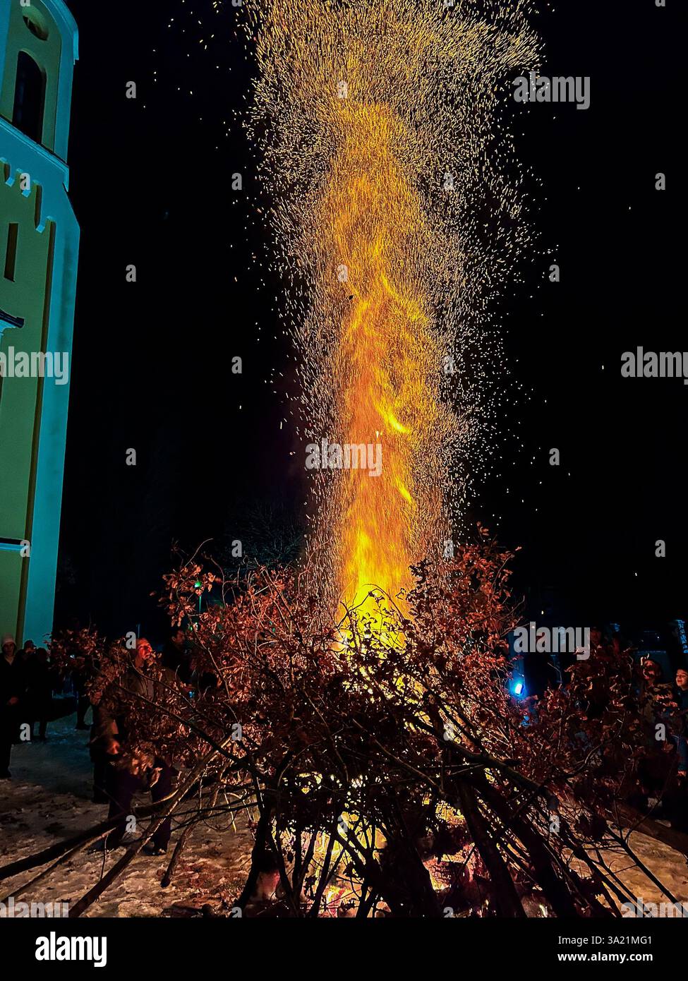 The lighting of the Yule log (Badnjak) on Christmas Eve, a cherished Serbian tradition symbolizing warmth, faith, and family unity - Smartphone Captured Stock Image
