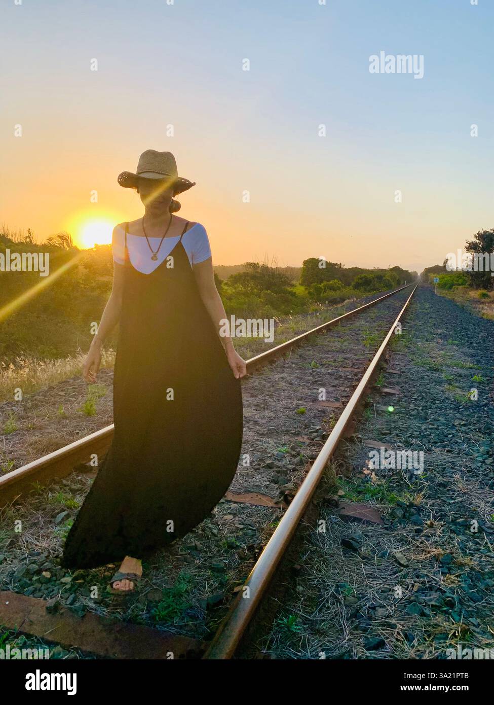 women walks on railroad tracks - Smartphone Captured Stock Image