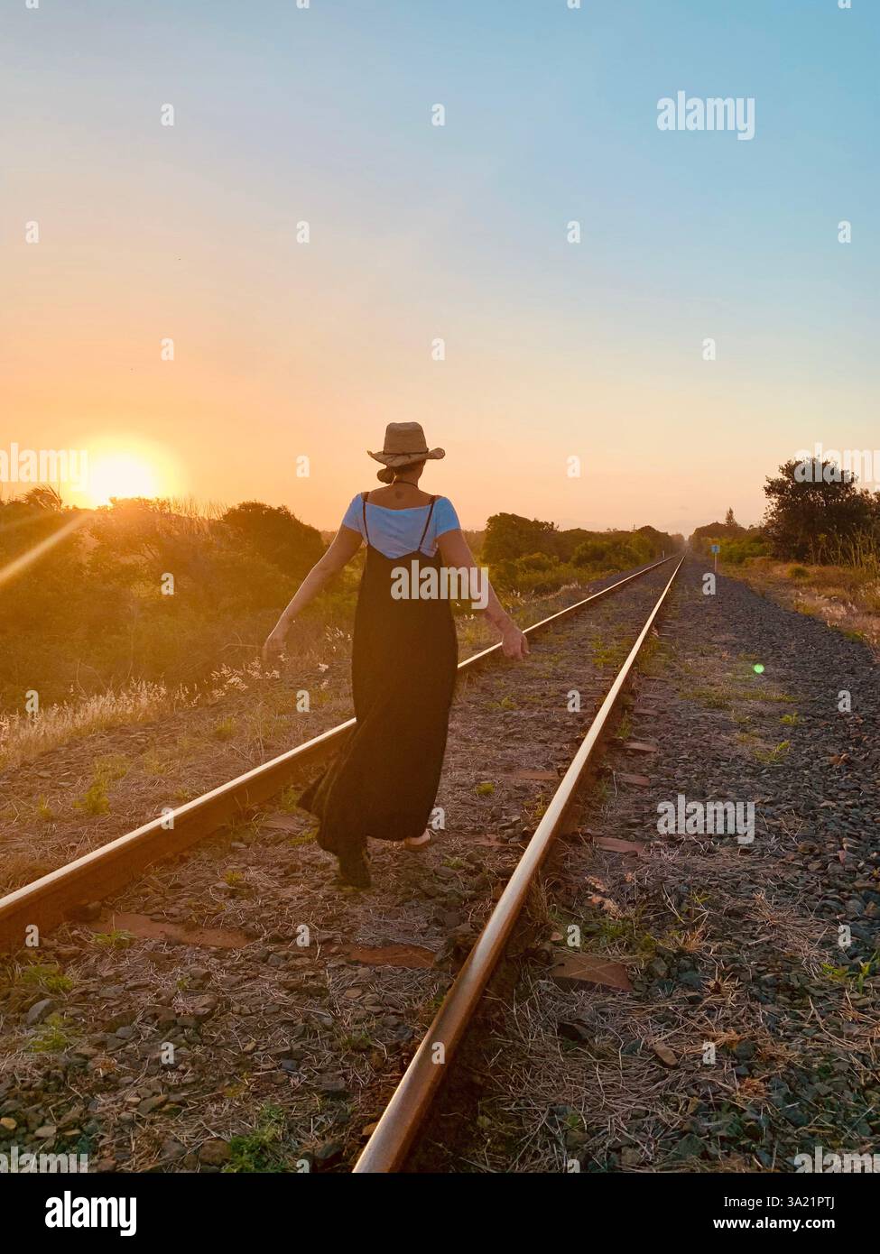 women walks on railroad tracks - Smartphone Captured Stock Image