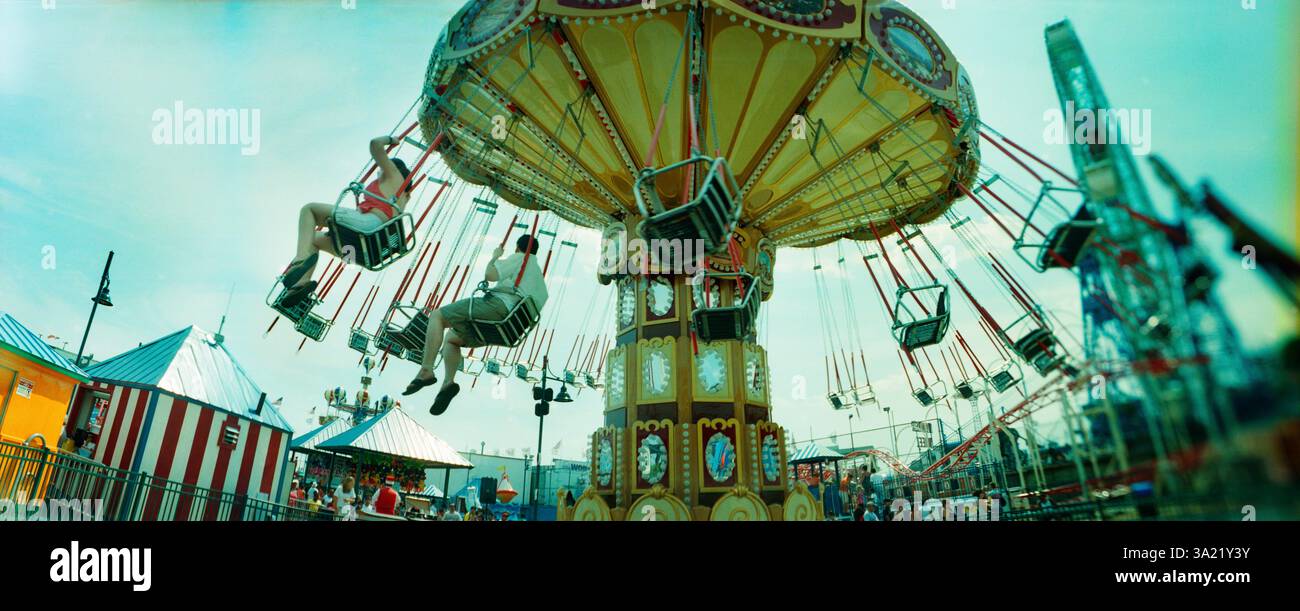 Panoramic view of tourists riding on an amusement park ride, Lynn's Trapeze, Luna Park, Coney Island, Brooklyn, New York City, New York State, USA Stock Photo