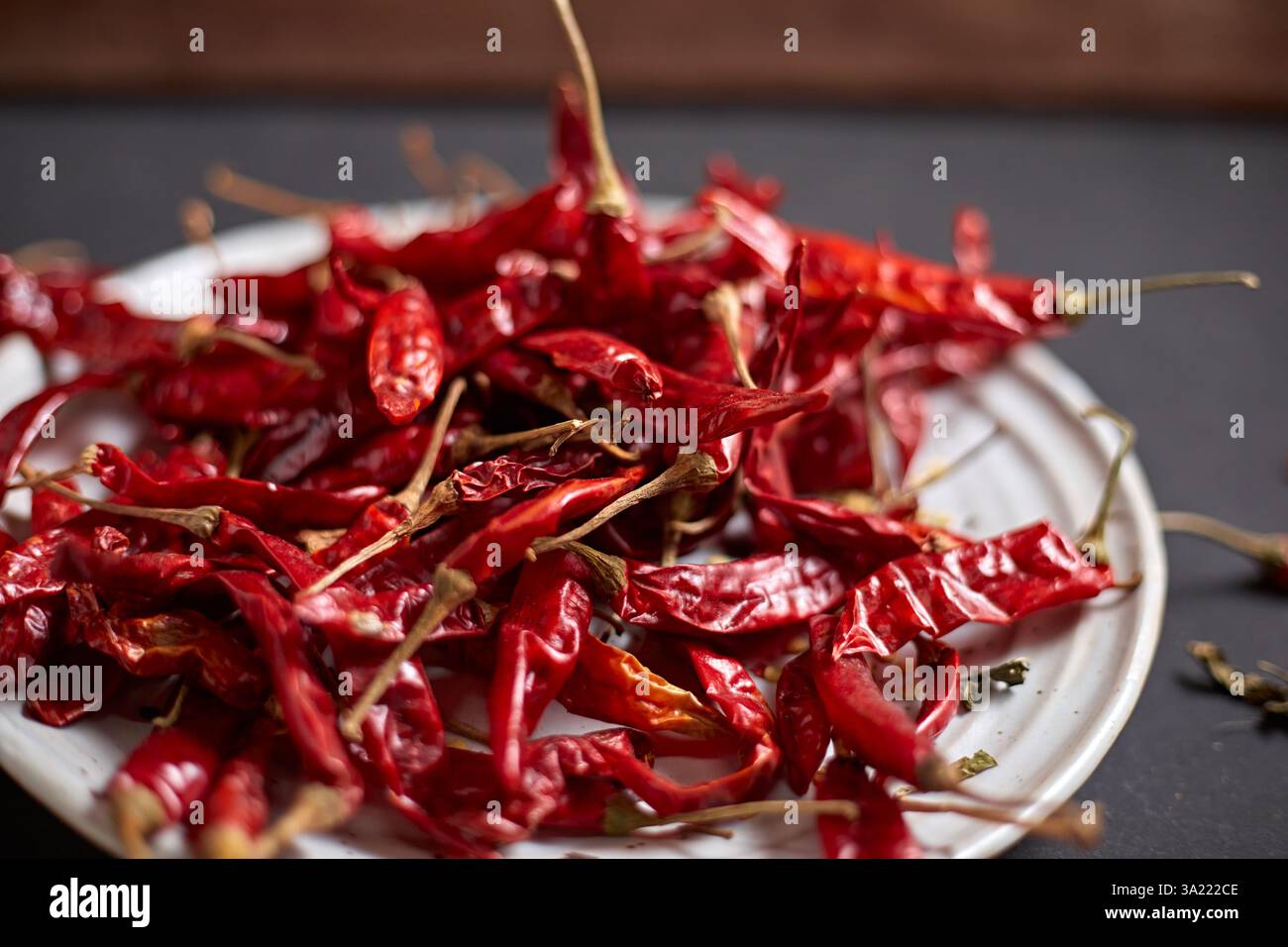 Dried chilli peppers on rustic dark background Stock Photo - Alamy