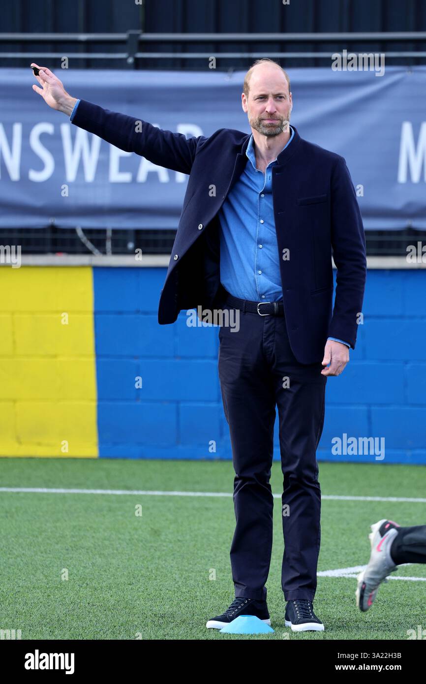 The Prince of Wales uses hand signals to referee during a mini football ...