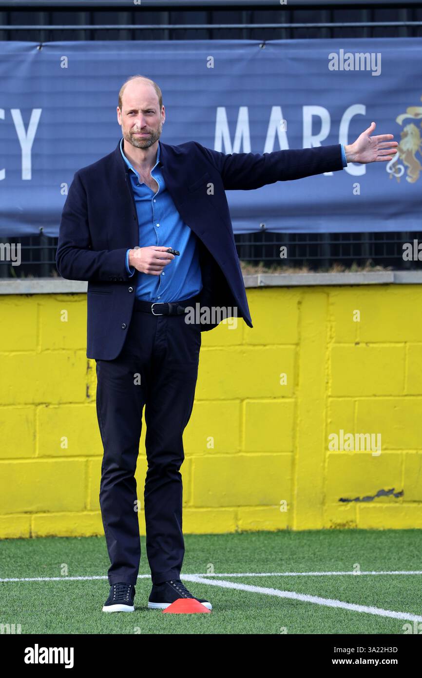 The Prince of Wales uses hand signals to referee during a mini football ...