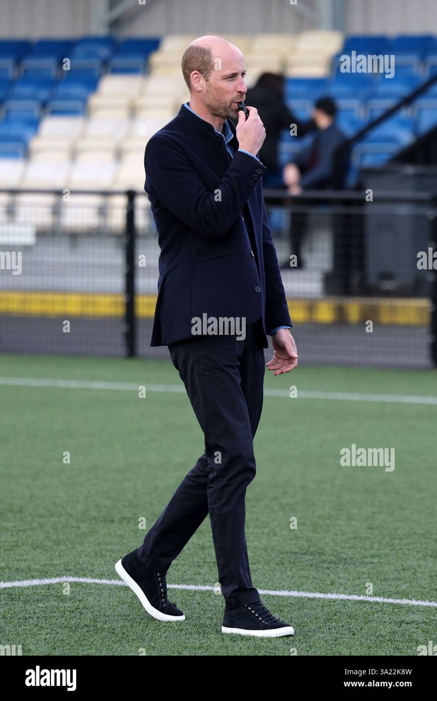 The Prince of Wales blows the referee's whistle during a mini football ...