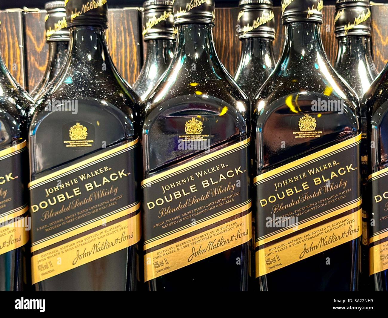 At sea, Atlantic Ocean - 5 January 2025: Close up view of a row of bottles of Johnnie Walker Double Black whisky on sale in a duty free shop. - Smartphone Captured Stock Image