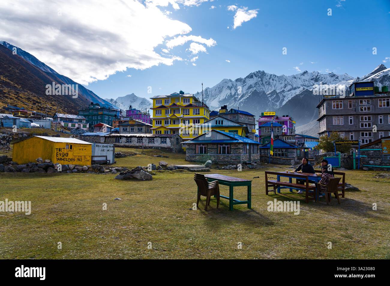 Langtang, Kyanjin, Nepal - October 18 2024 : Tea Houses and loges seen in Kyanjin Gompa Village with Himalayan Range in Front Stock Photo