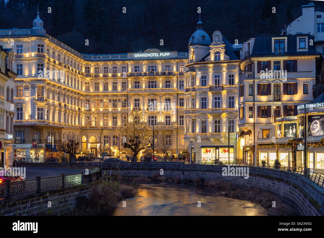 This is a night view of the famous Grandhotel Pupp, a luxury spa hotel along the riverside on December 23, 2024 in Karlovy Vary, Czech Republic Stock Photo