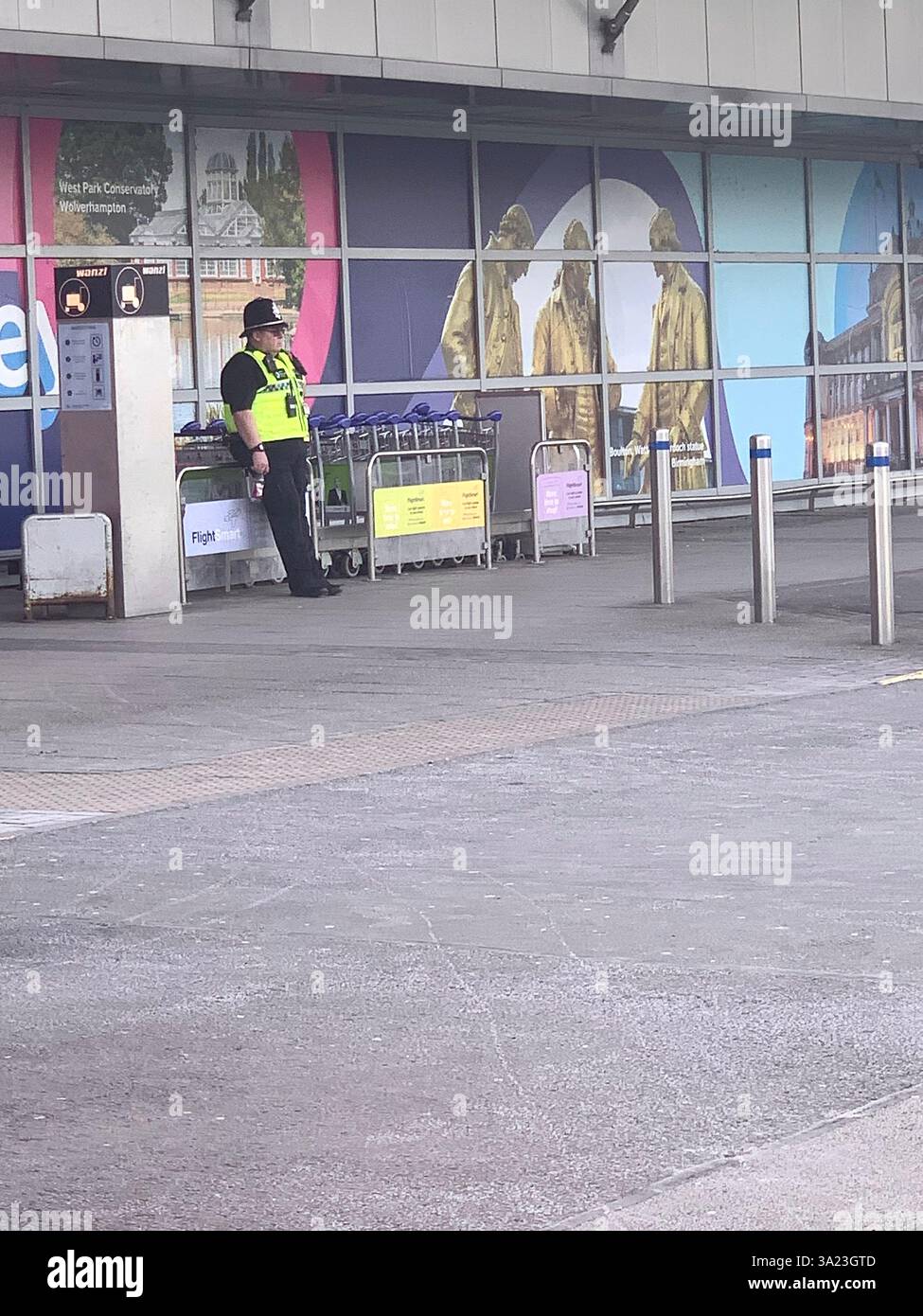 Jet 2 in flight trolley airliner passengers passenger staff working sell selling goods tea beer drink food Birmingham Police Policeman waiting sit sat - Smartphone Captured Stock Image