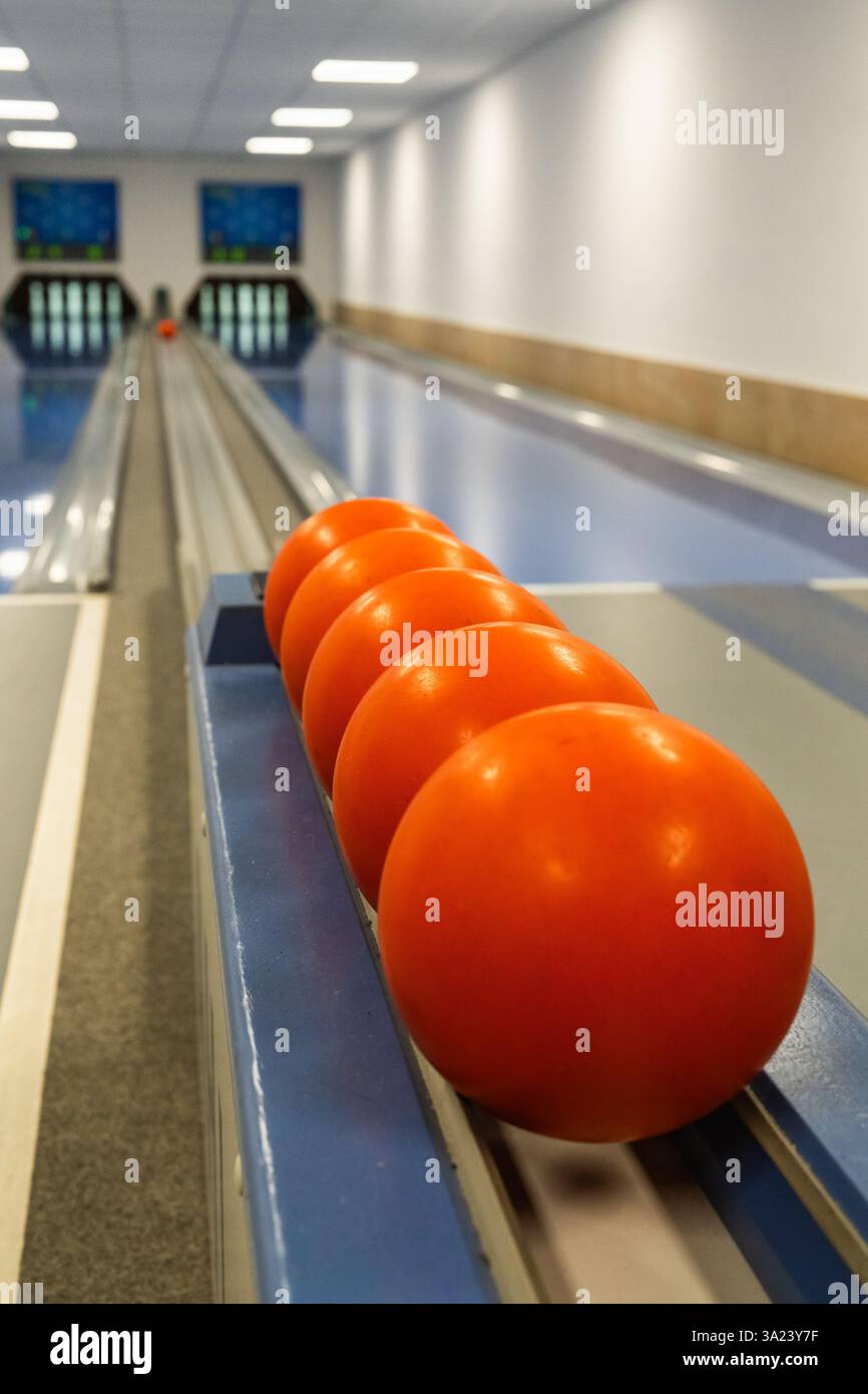 Bowling balls on bowling lane with pins in background. Stock Photo