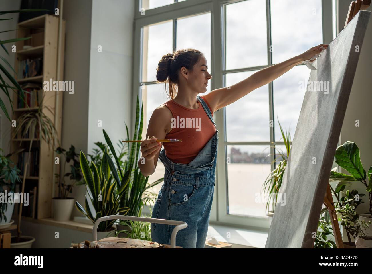 Positive optimistic woman painter embodies creative ideas expresses ...
