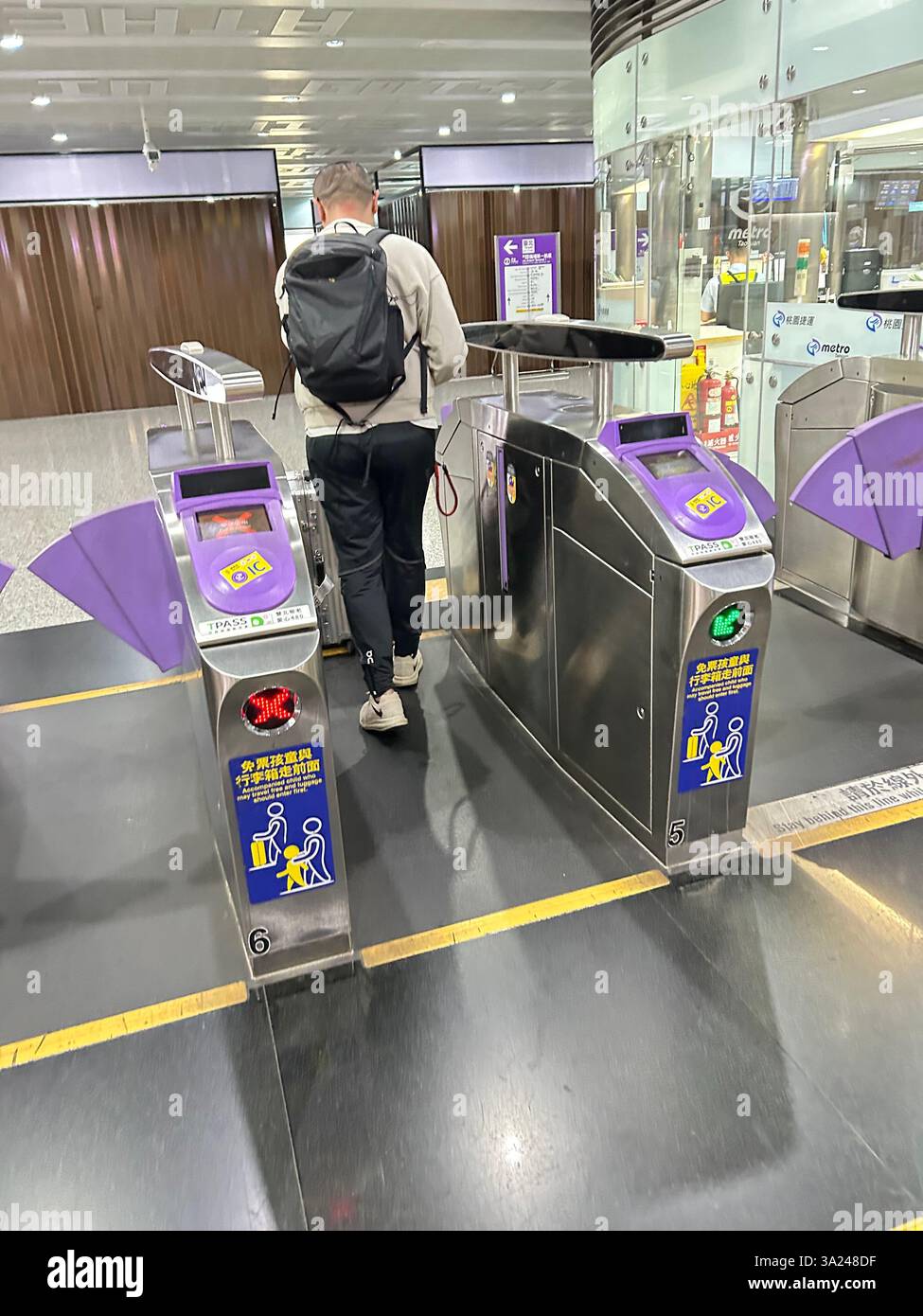 Taipei, Taiwan, Man entering Metro from Turnstiles, View inside Metro, tube train busy subway entrance - Smartphone Captured Stock Image