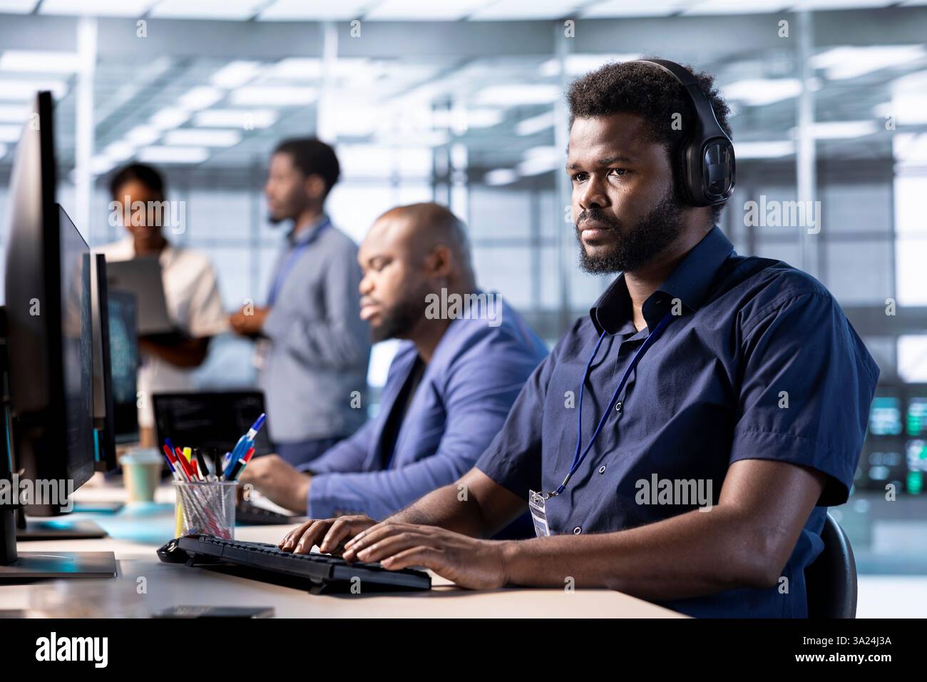 Data center worker hearing songs in headphones while using programming languages to construct algorithms and build applications. Server hub employee listening music, debugging and optimizing code Stock Photo