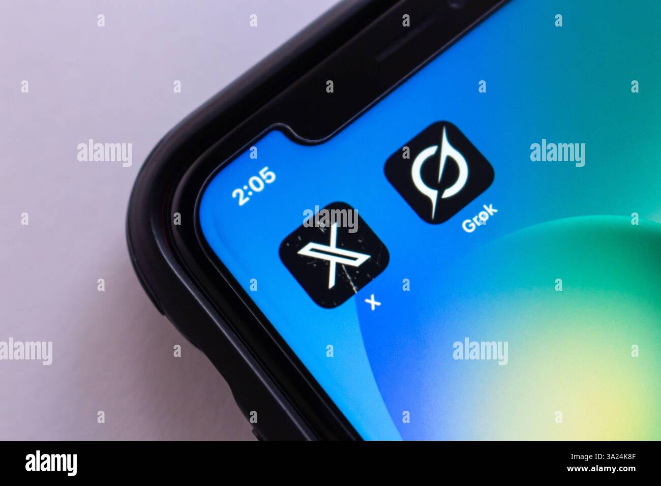 Mexico City, MEXICO - Mar 11 2025 : X app and Grok displayed on an iPhone screen, symbolizing modern AI-driven social media and technology. Stock Photo