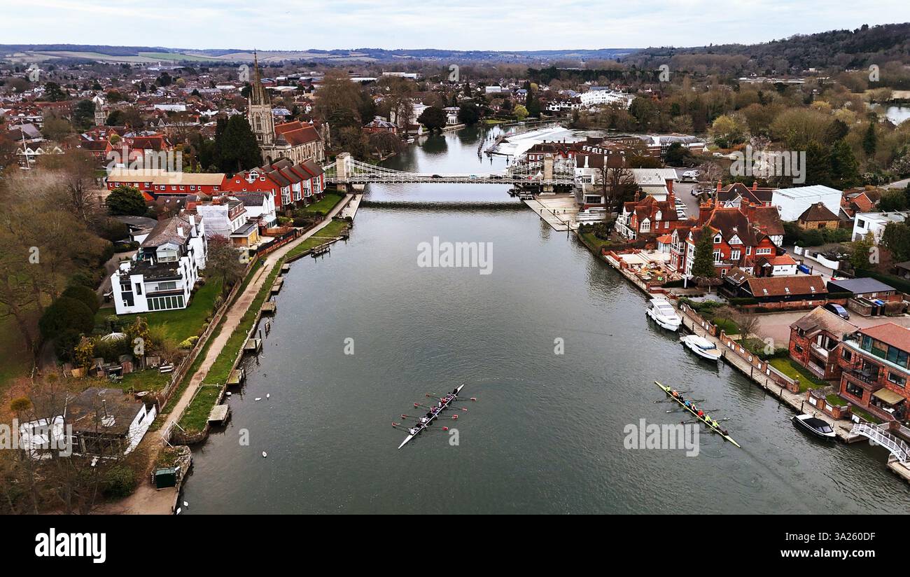 Rowers pass alongside one another on the River Thames in Marlow, Buckinghamshire, UK. Picture