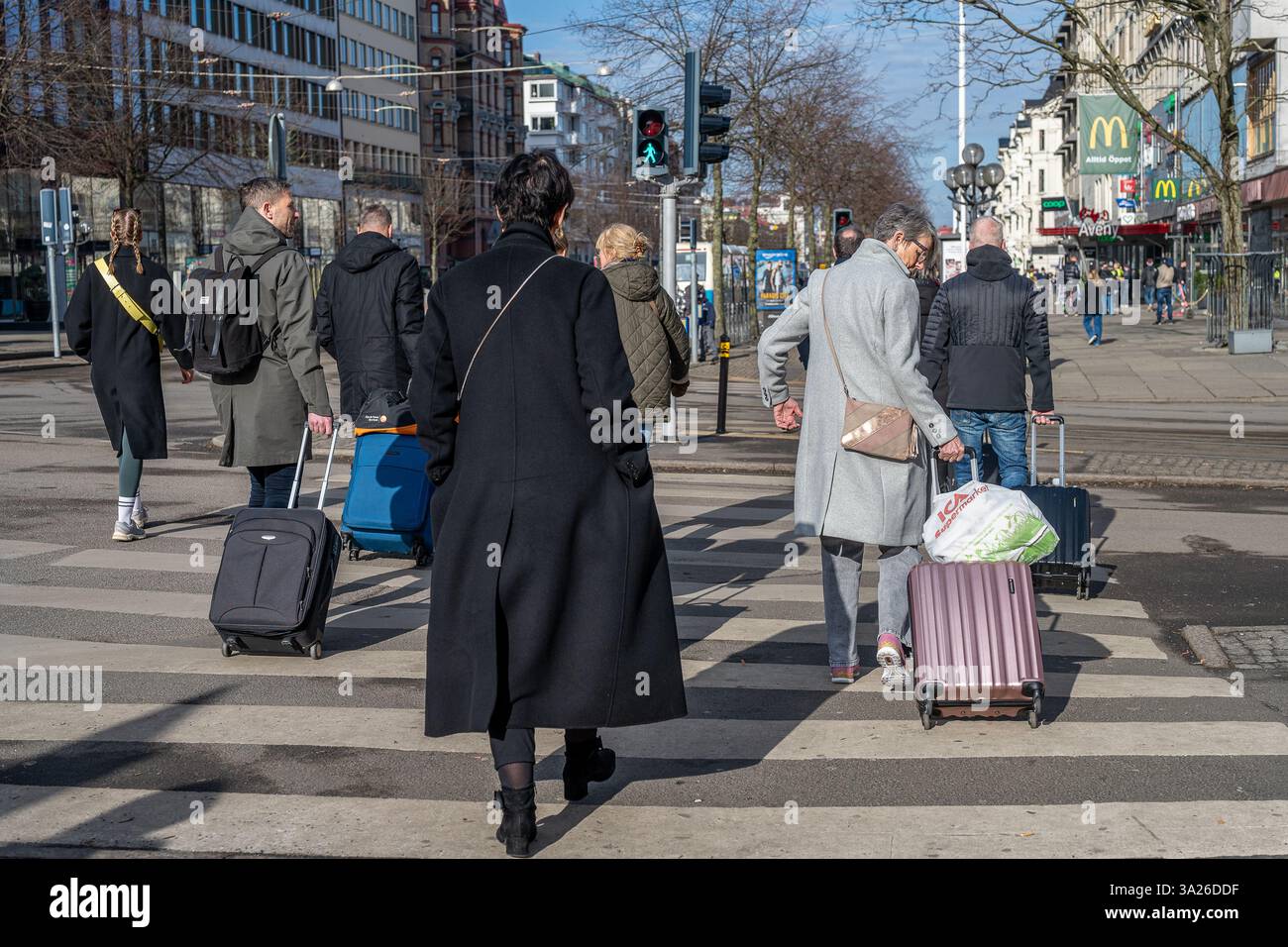 People stroll on main street Kungsportsavenyn in  Gothenburg on a sunny spring day in March 2025. Gothenburg is the second largest city in Sweden. Stock Photo