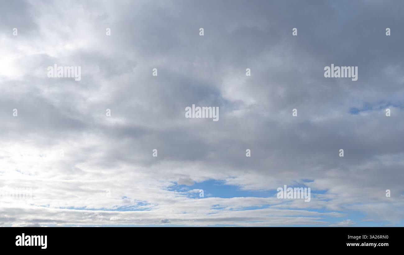 Fluffy clouds covering a morining blue sky Stock Photo