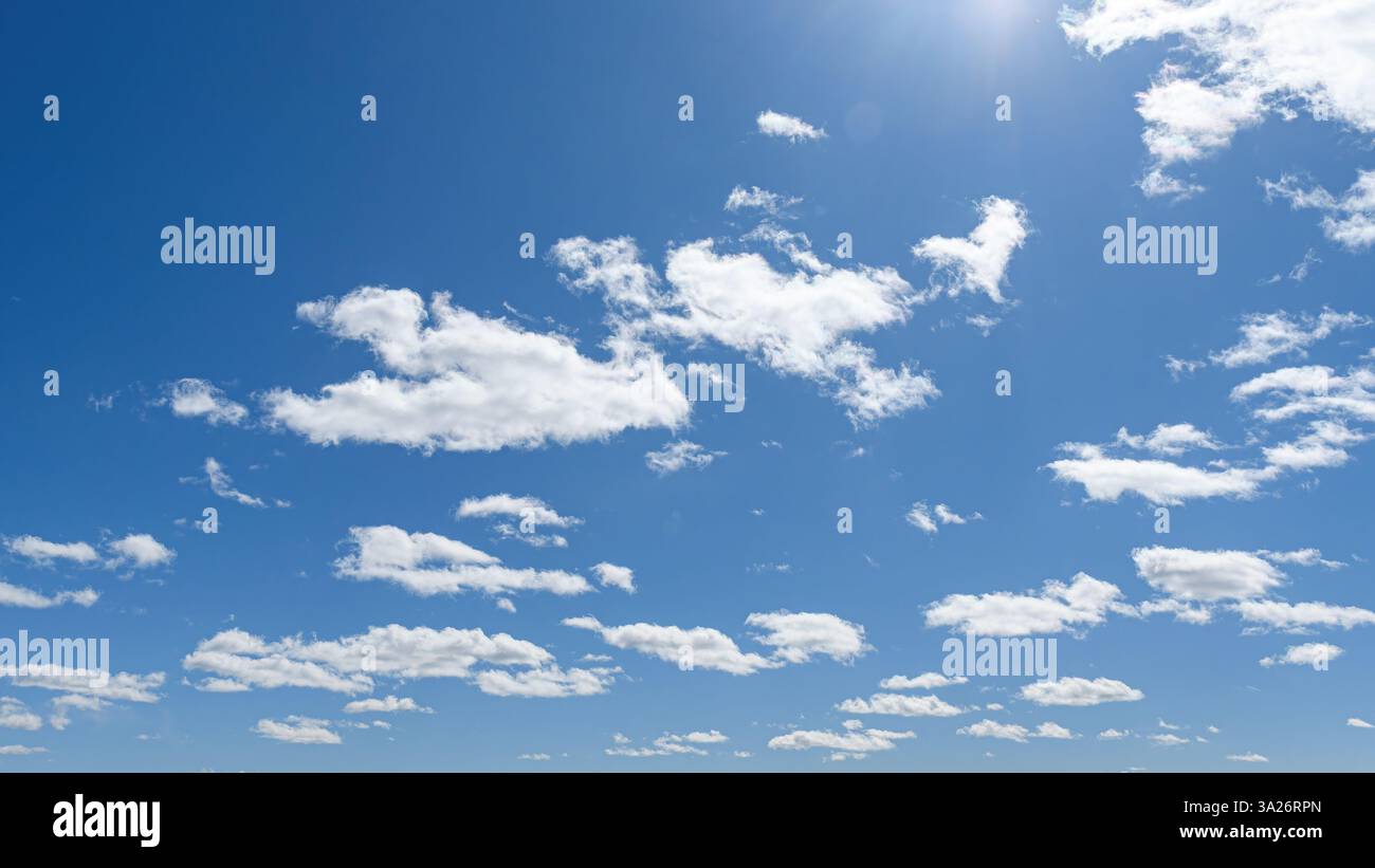 White clouds and sunlight in a blue sky Stock Photo