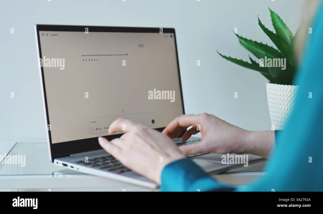 Tallinn, Estonia - 2025.03.08: Woman interacting with ChatGPT AI on a computer. Stock Photo